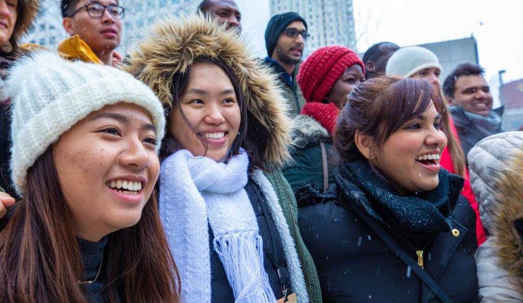 Group of international students smiling in the light snow